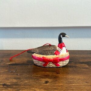Vintage 1986 duck Christmas ornament with red scarf neck in basket with red bow